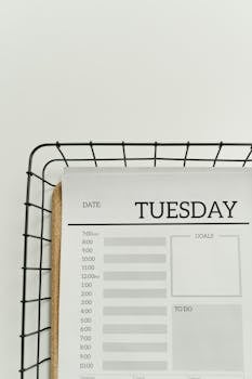 A minimalist planner displaying a Tuesday schedule with time slots, goals, and to-do sections.
